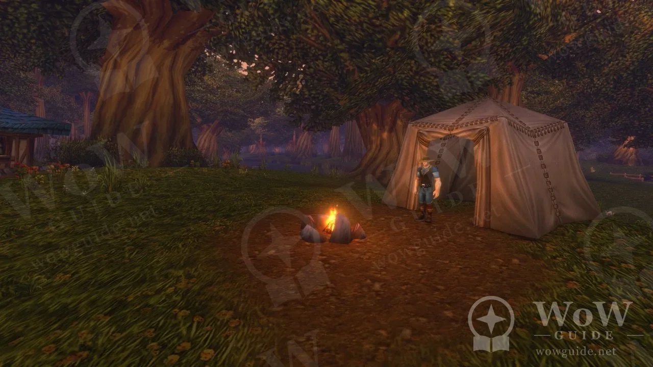 Tent and campfire under a tree at dusk
