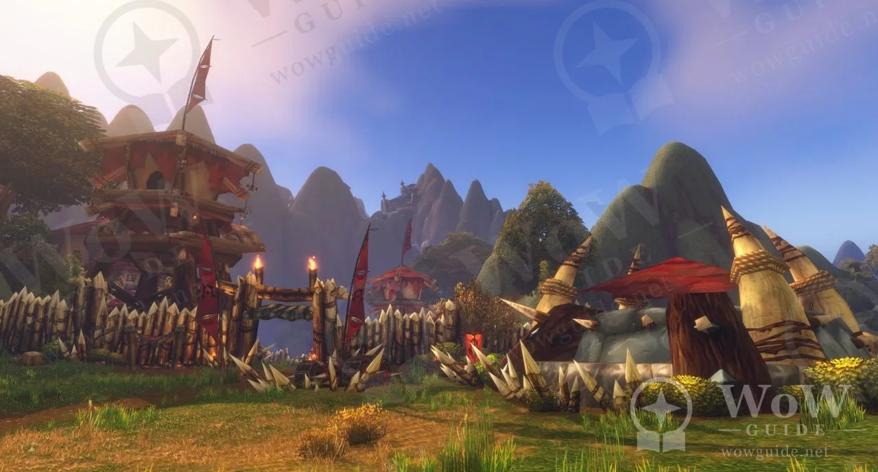 In-game settlement with red-roofed buildings and a watchtower