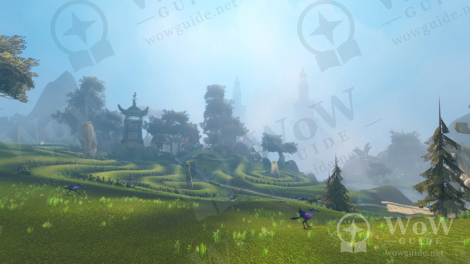 In-game shot of green terraced hills and towers in the mist
