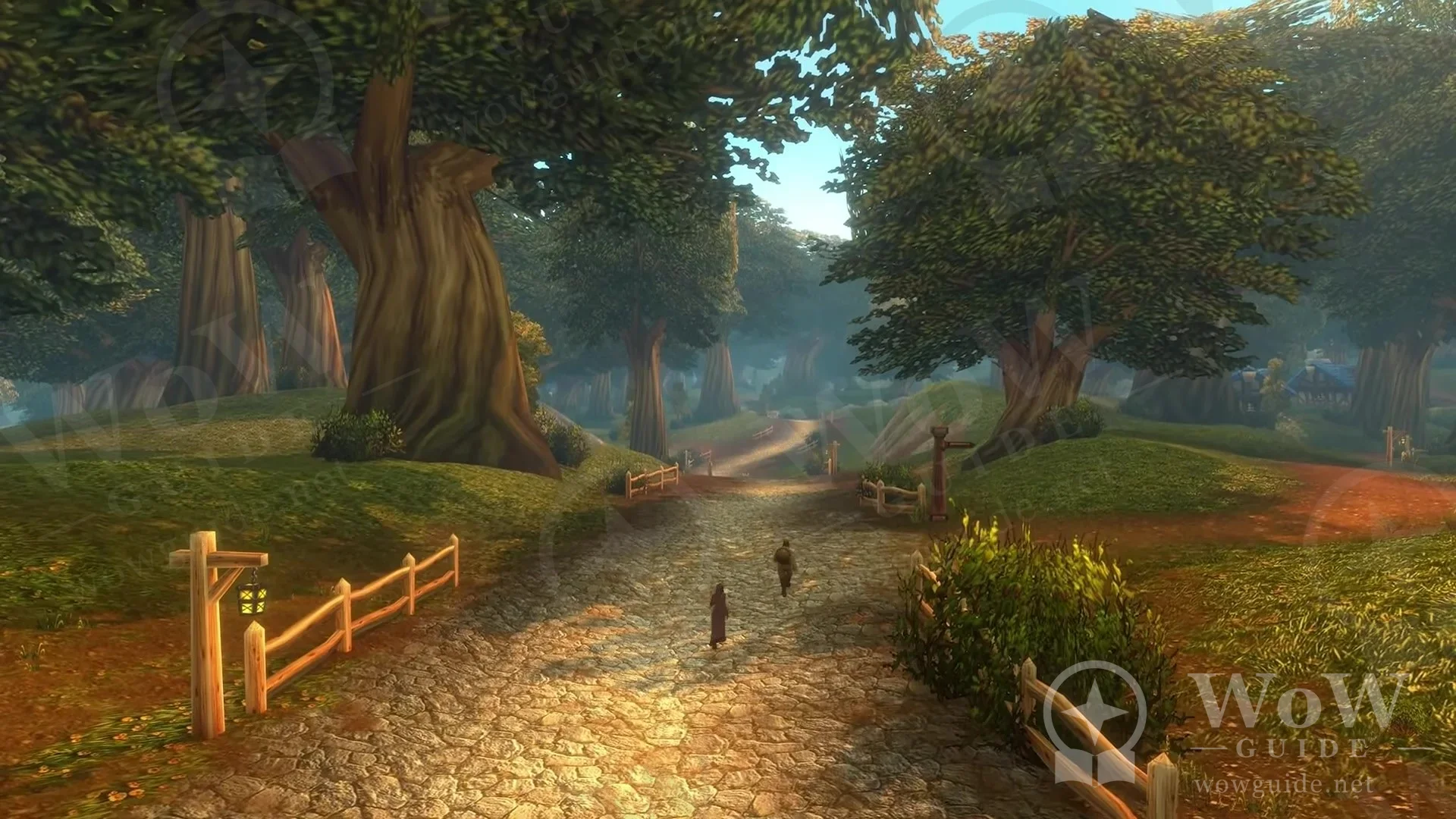 A fenced dirt road through leafy trees with small characters walking along it